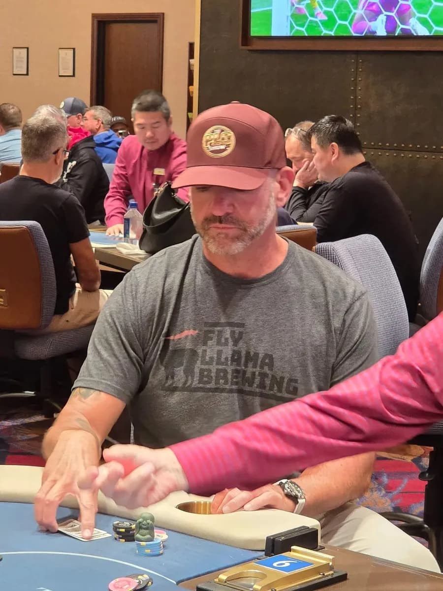 PLO Show fan in the maroon snapback at a live poker room table