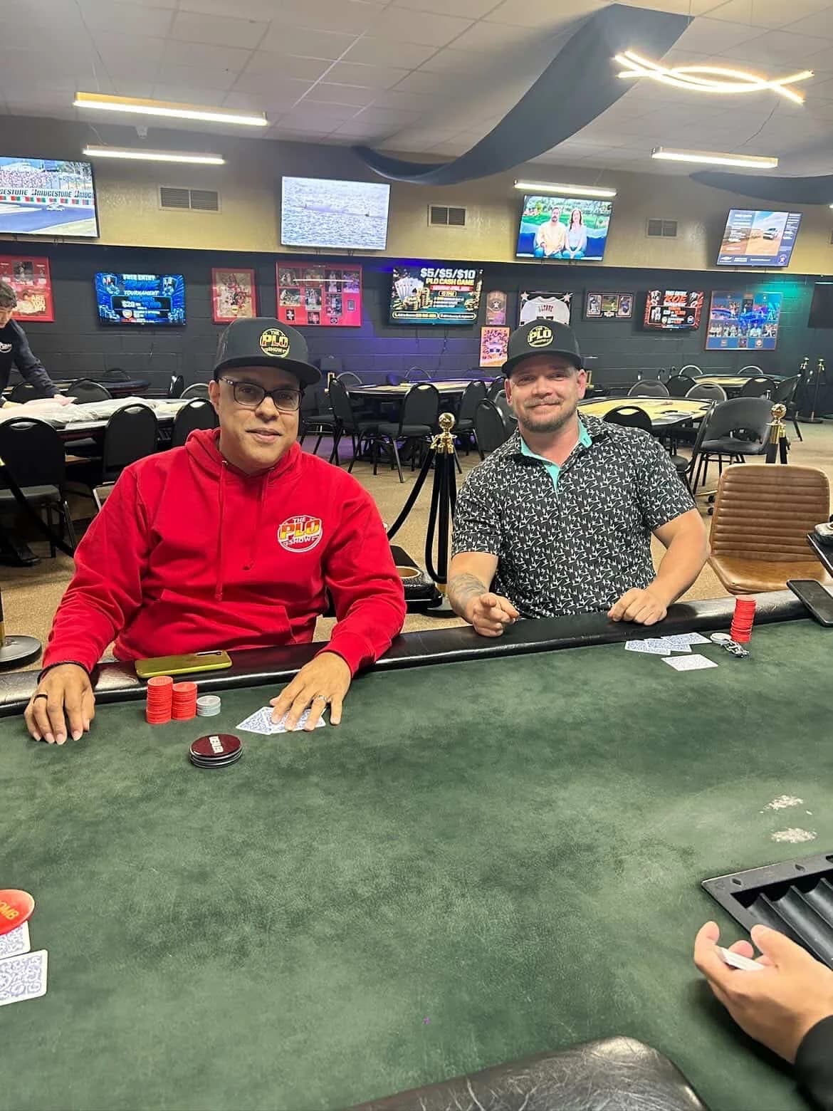 Two PLO Show fans wearing the red hoodie and snapback at the poker room
